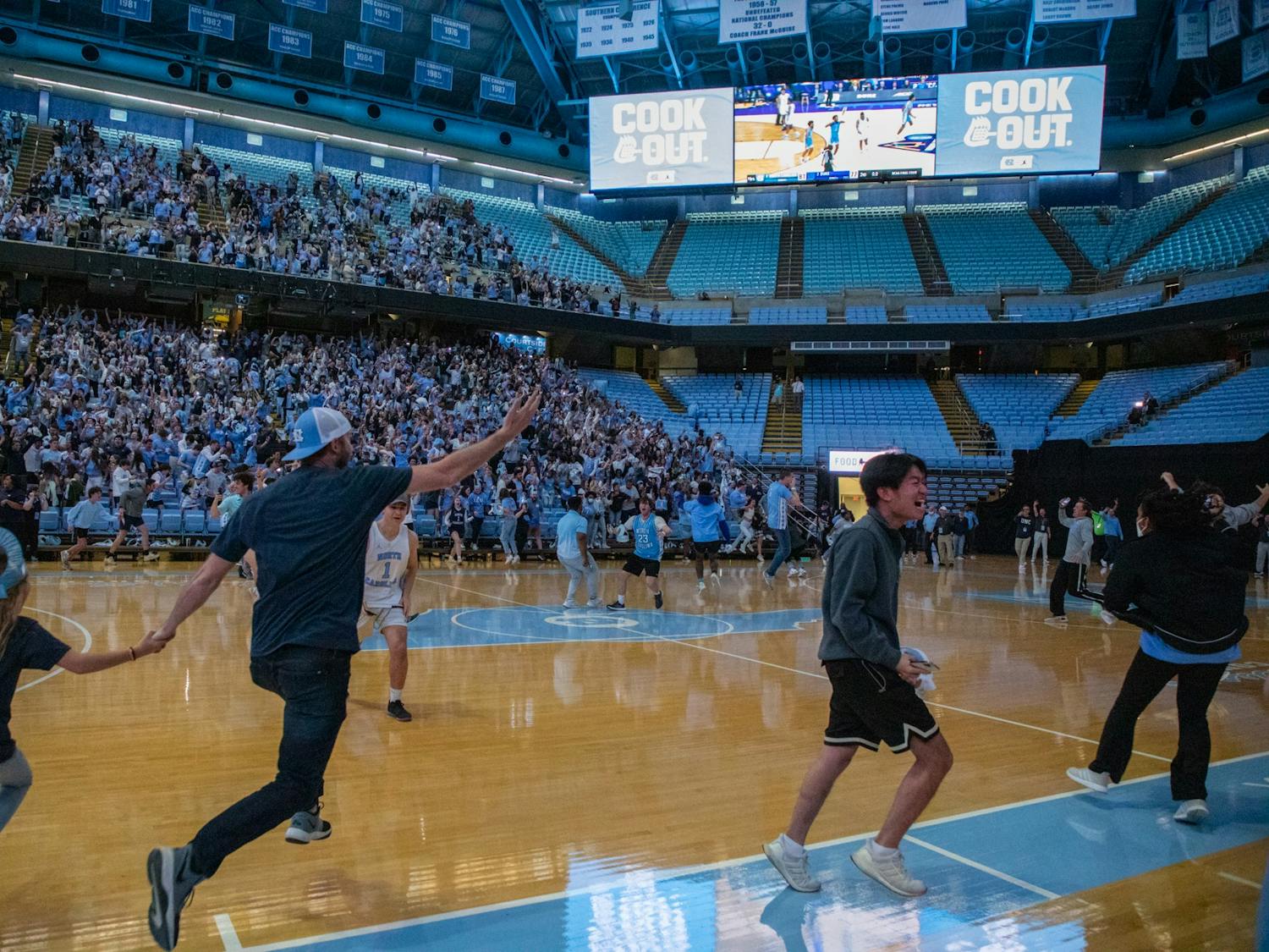 Fans storm the court at the Dean Smith Center after UNC beat Duke 81-77 in the Final Four on Saturday, April 2, 2022.