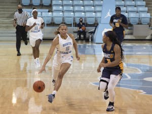 Graduate guard Stephanie Watts (5) drives the ball during the game against UNC-Greensboro in Carmichael Arena on Saturday, Nov. 28, 2020. The Tar Heels defeated the Spartans 96-35.