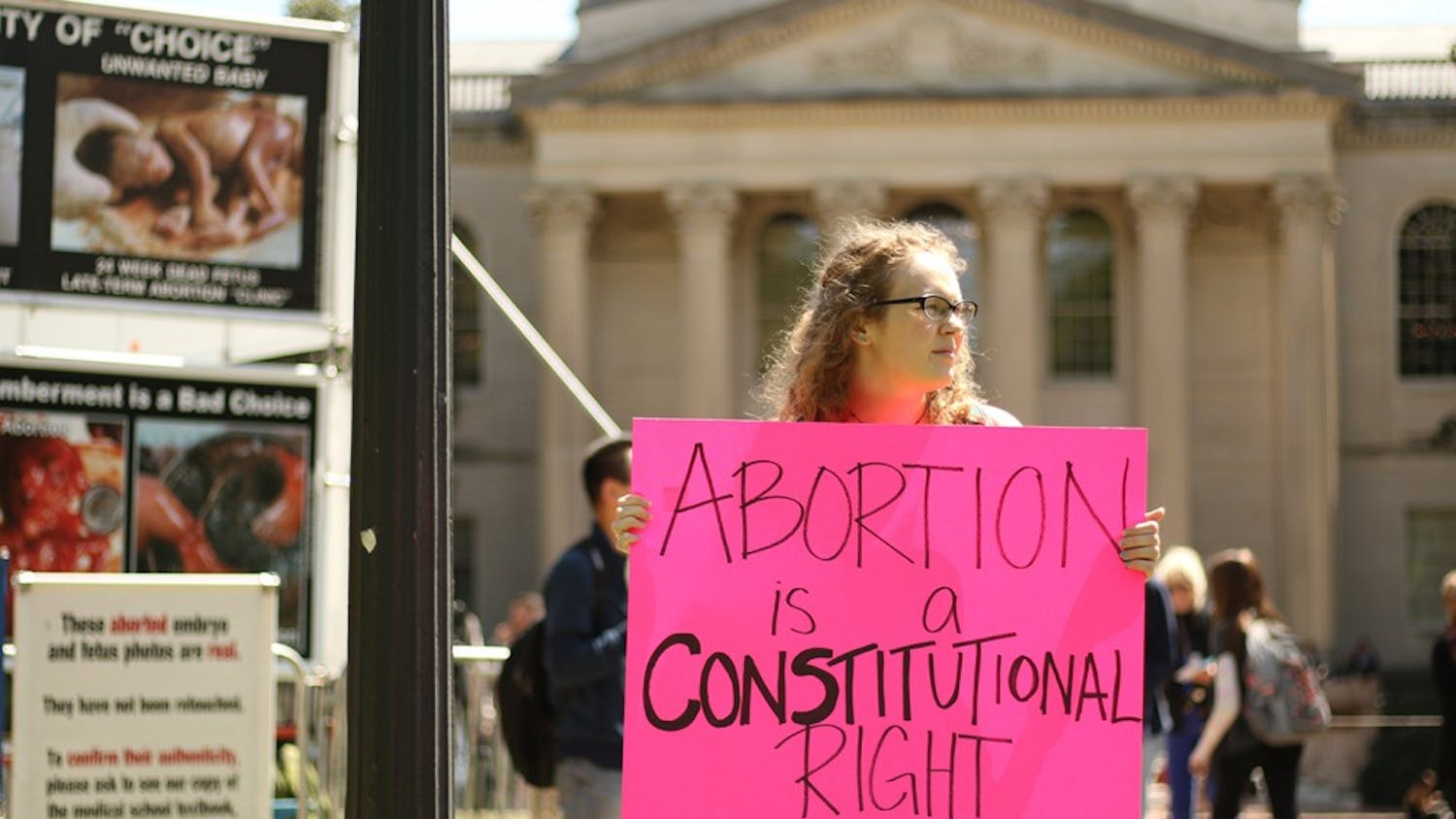 Senior geology major Michelle Gavel participates in the counter-protest against anti-abortion group the Genocide Awareness Project. Gavel was invited to protest the display by friends with shared views, and expresses disappointment in GAP's return to campus.