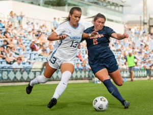 Junior forward Isabel Cox (13) runs with the ball at the game against Virginia on Oct. 3 at Dorrance Field. UNC tied 0-0.