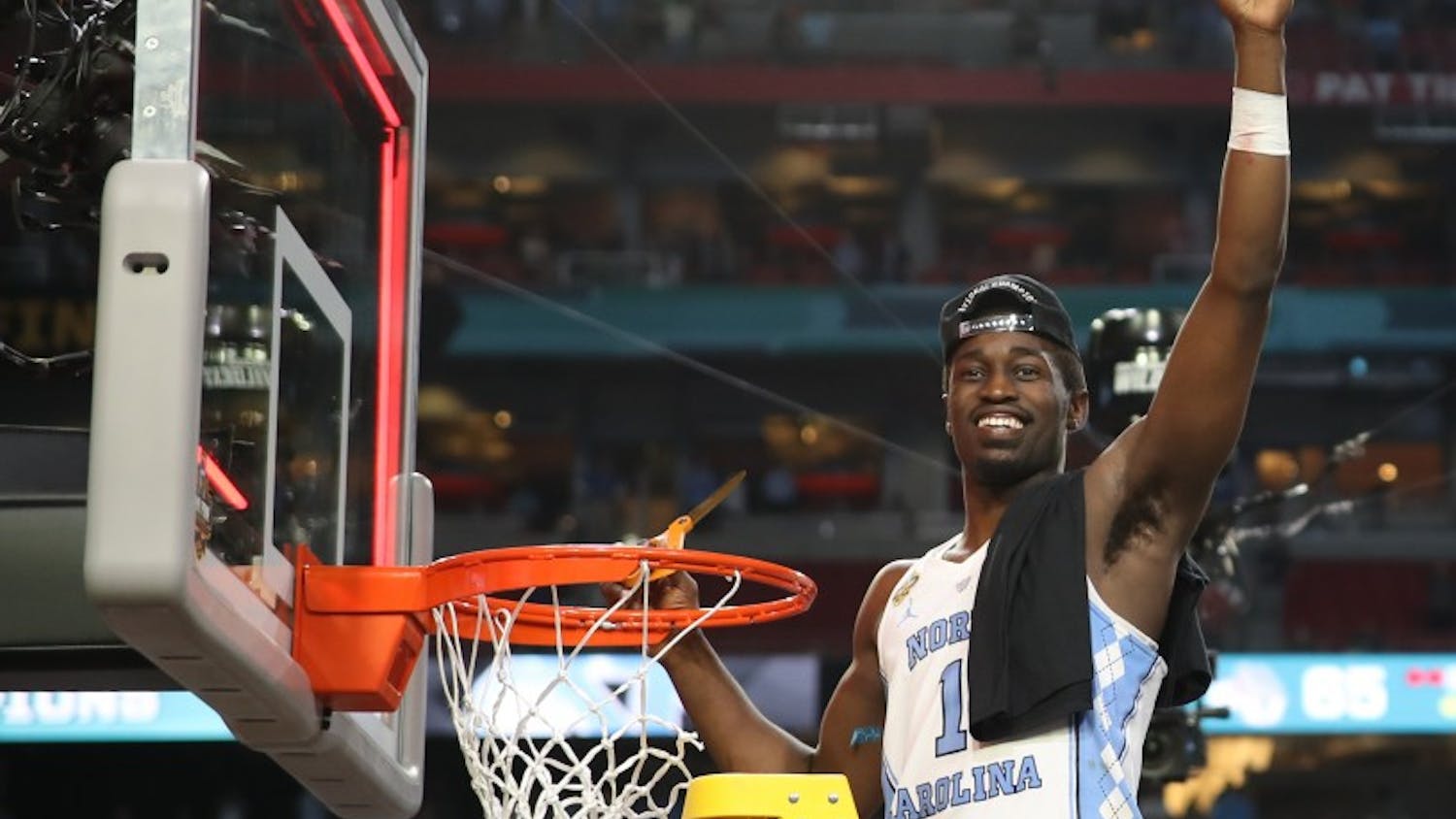 North Carolina wing Theo Pinson (1) holds up his part of the cut down net after defeating Gonzaga 71-65 in the NCAA men's basketball Championship Monday night in Phoenix.