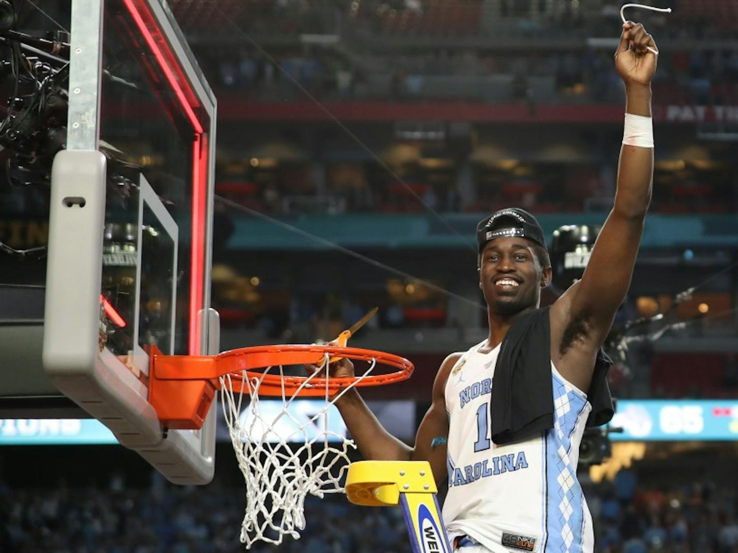 North Carolina wing Theo Pinson (1) holds up his part of the cut down net after defeating Gonzaga 71-65 in the NCAA men's basketball Championship Monday night in Phoenix.