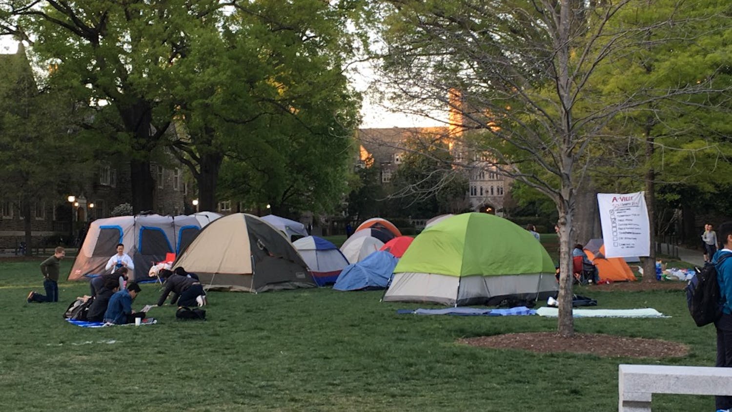  Protestors encamped on Abele Quad eat dinner before the sun sets over Duke University on Monday evening. Volunteer faculty and organizations such as the Duke Center for Multicultural Affairs donated seventeen tents, food and other supplies to the protesters.