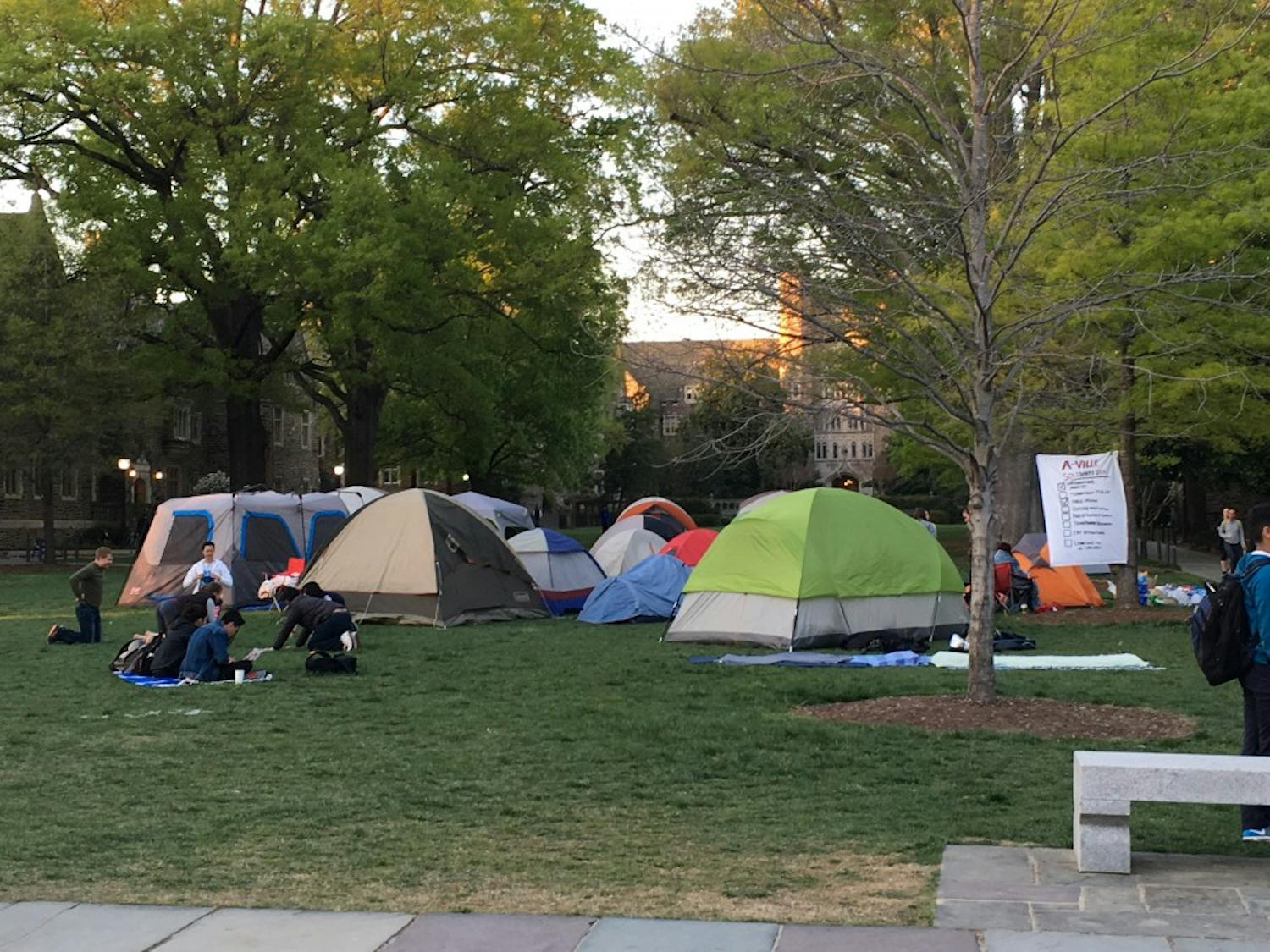 Protestors encamped on Abele Quad eat dinner before the sun sets over Duke University on Monday evening. Volunteer faculty and organizations such as the Duke Center for Multicultural Affairs donated seventeen tents, food and other supplies to the protesters.