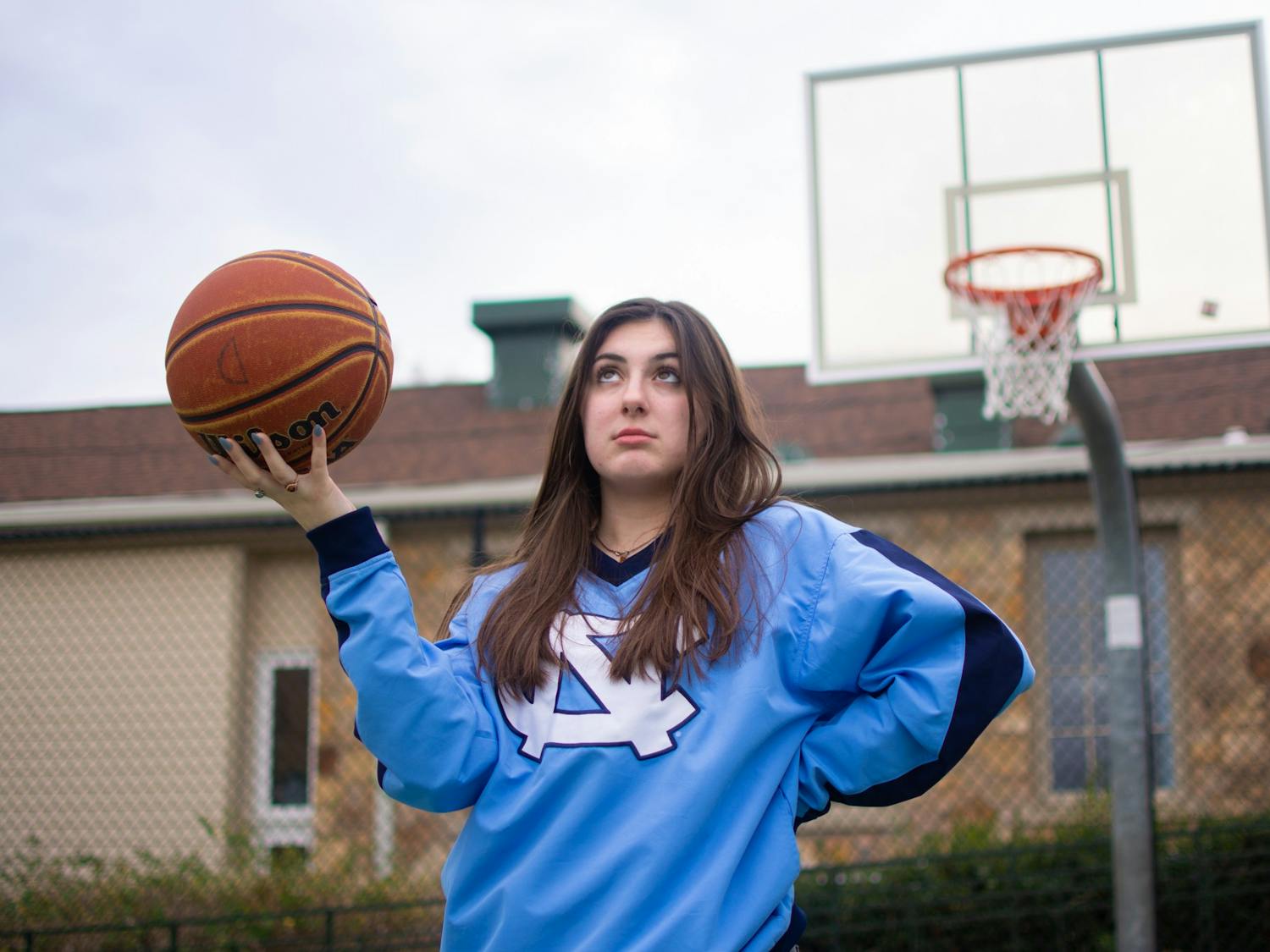 Caitlyn Yaede, Opinion Editor, poses with a basketball in preparation for the UNC vs. Duke game on this weekend.