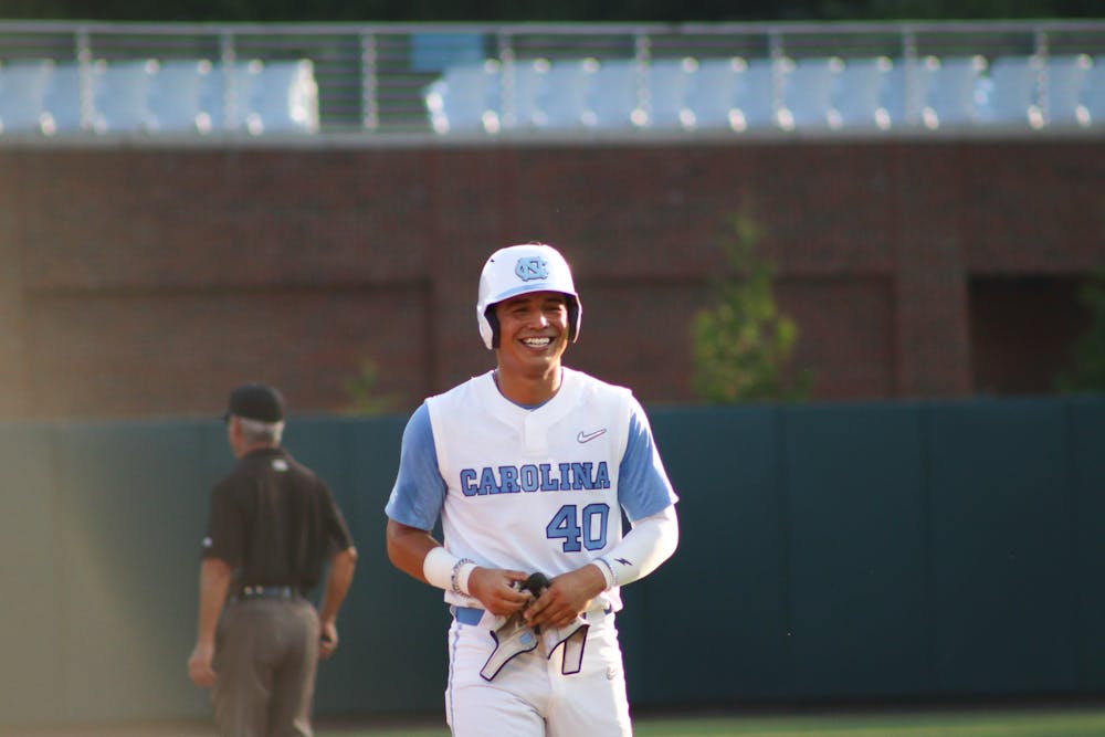 Redshirt junior right fielder Angel Zarate (40) smiles as he walks off the field to the dugout. UNC won 10-4 against FSU at home in the second game of the three-game series on Friday, May 20, 2022.