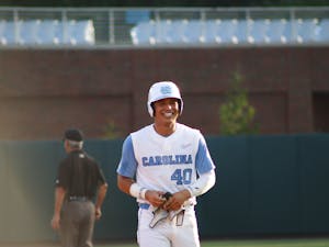 Redshirt junior right fielder Angel Zarate (40) smiles as he walks off the field to the dugout. UNC won 10-4 against FSU at home in the second game of the three-game series on Friday, May 20, 2022.