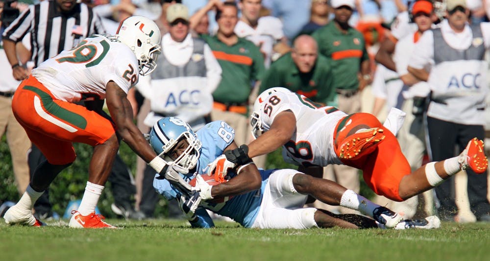UNC wide receiver Dwight Jones is brought down by Miami's defense in the game on Saturday. UNC lost to Miami 30-24. 