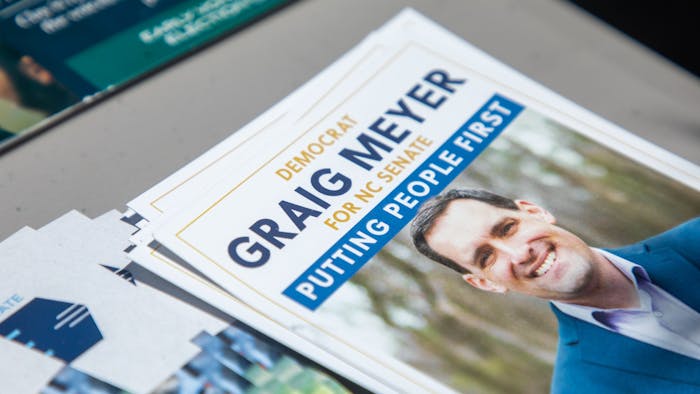 Campaign paraphernalia for Graig Meyer sits outside a polling place on May 17, 2022.