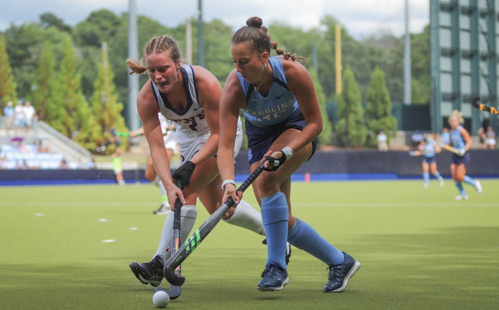 Sophomore forward Kennedy Cliggett (36) clashes sticks with a UPenn player as she fights for the ball. UNC beat UPenn at home 4-0 on Sunday, Sept. 4, 2022.