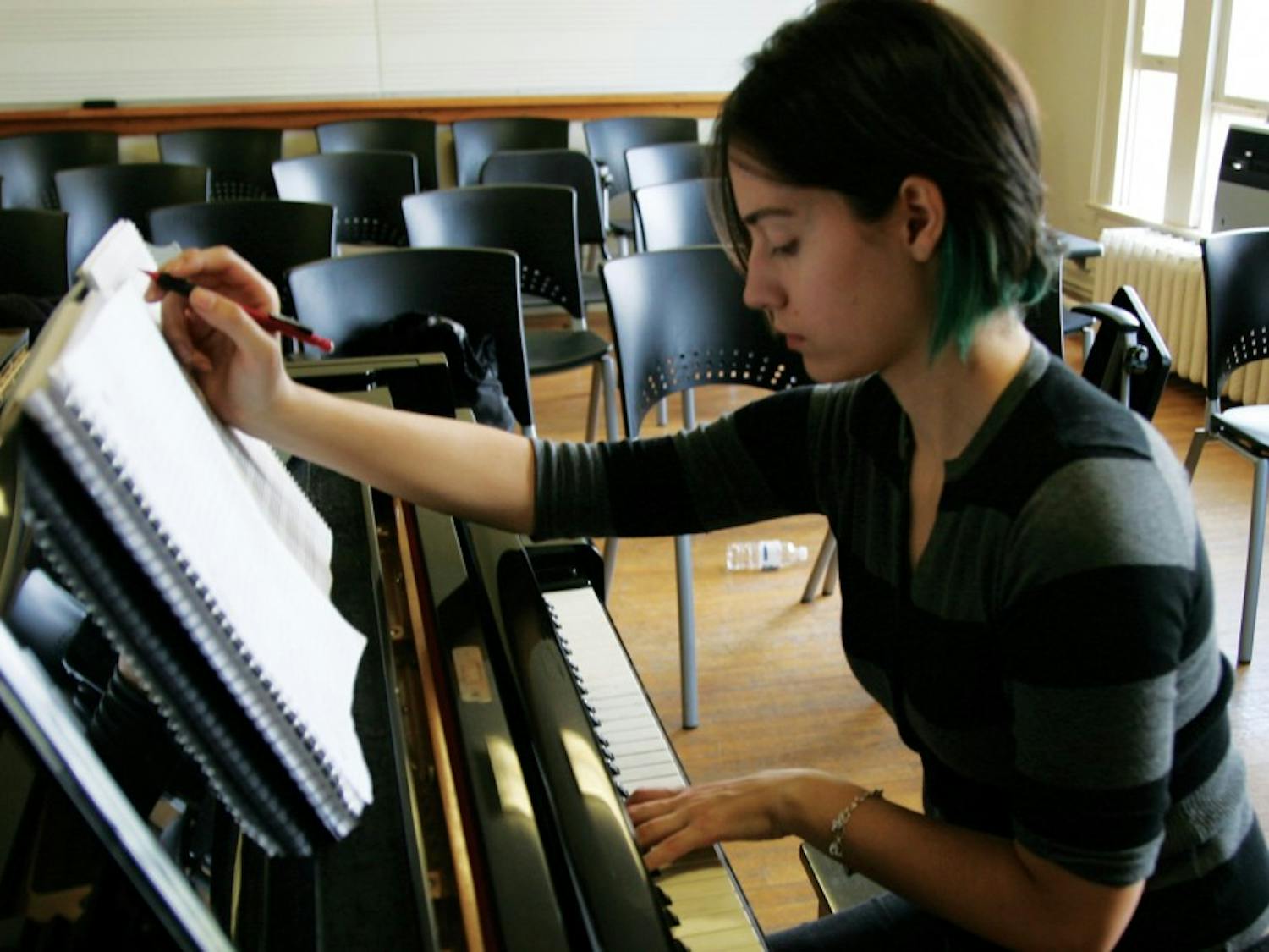 	Trinity Velez works in Hill Hall on her latest composition, a complex, eight-voice choral piece. Velez hopes to eventually work in Hollywood composing film scores.