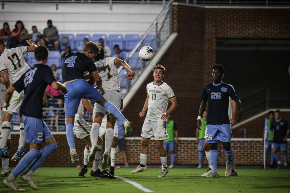 Freshman defender Blake Malone (4) heads the ball to score a goal during their game against Notre Dame on Friday, Sep. 20, 2019. UNC beat Notre Dame 2-0.