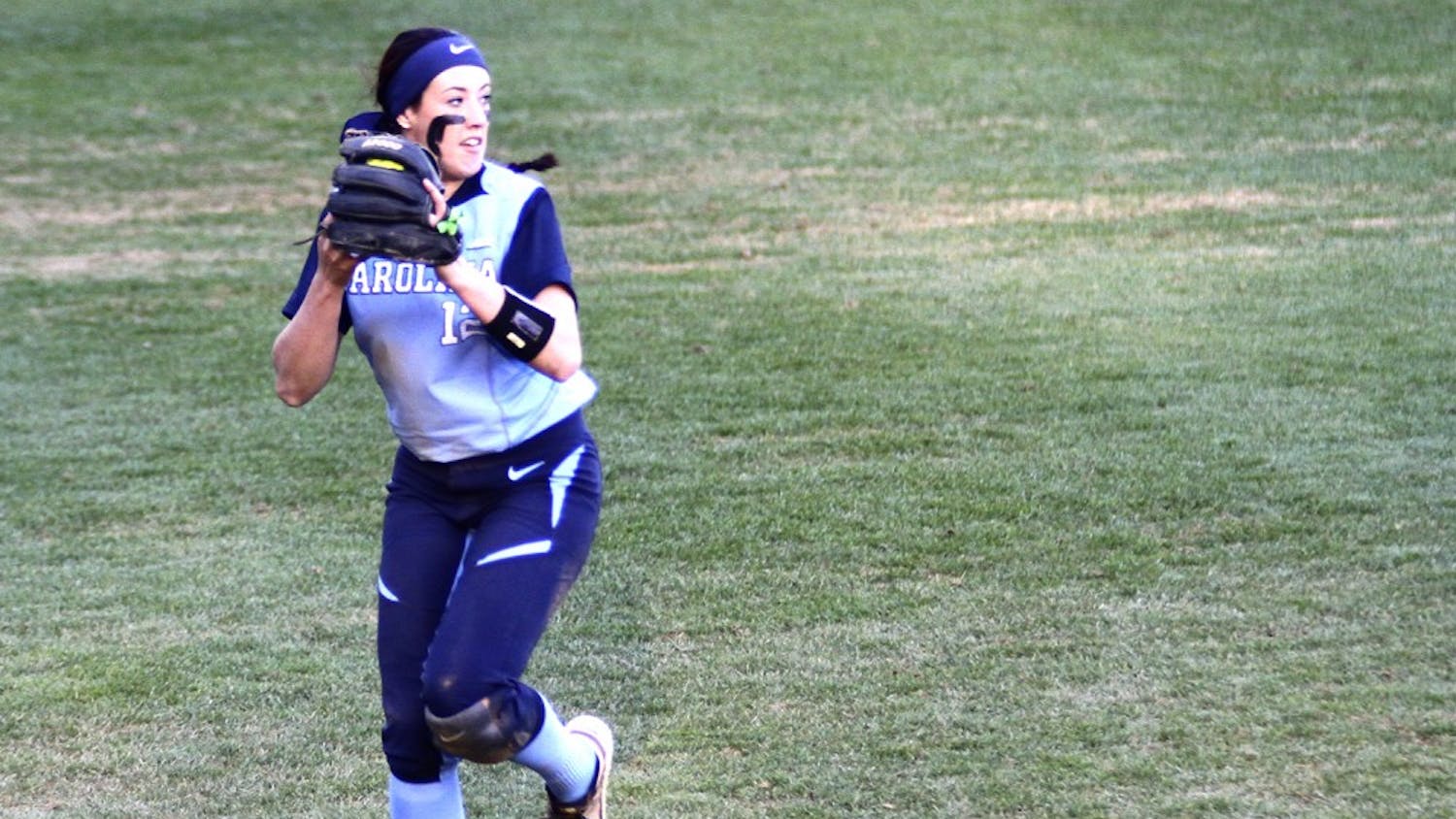 Kristen Brown (12) tosses off the ball during the softball game against Georgetown University on February, 28.