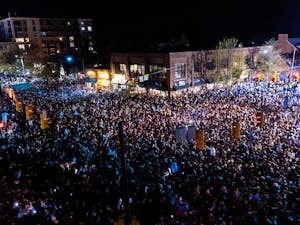 Fans rush Franklin Street after a historic North Carolina men's basketball win over Duke in the Final Four game on April 2, 2022. UNC won 81-77.