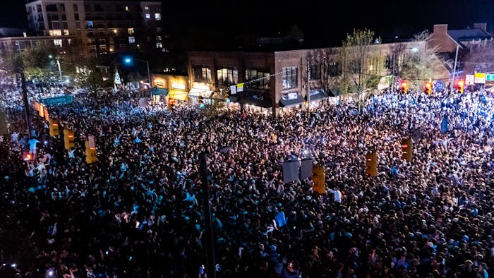 Fans rush Franklin Street after a historic North Carolina men's basketball win over Duke in the Final Four game on April 2, 2022. UNC won 81-77.