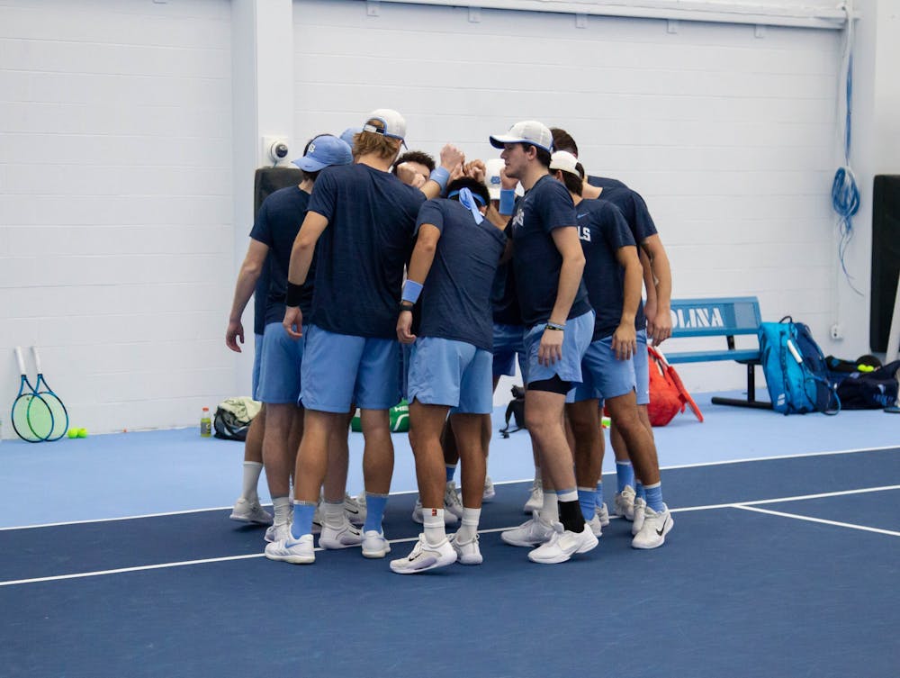 The UNC men's tennis team gathers before the game against Oklahoma State at the Cone-Kenfield Tennis Center on Saturday, Jan. 28, 2023. UNC beat Oklahoma State 4-0.