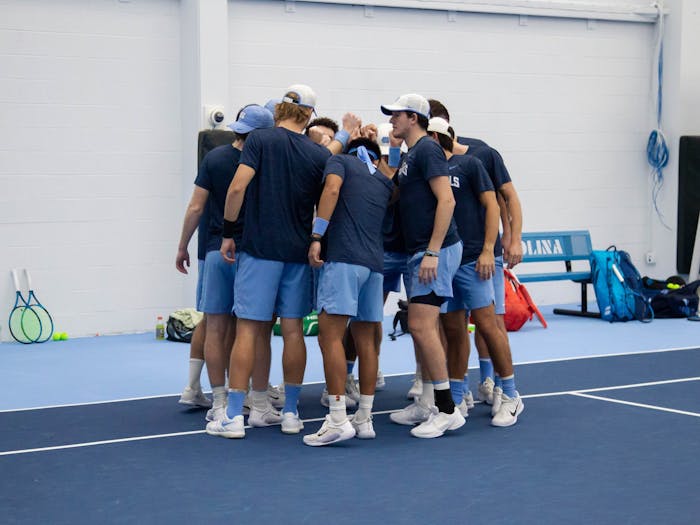 The UNC men's tennis team gathers before the game against Oklahoma State at the Cone-Kenfield Tennis Center on Saturday, Jan. 28, 2023. UNC beat Oklahoma State 4-0.