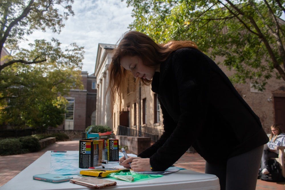 Cassie Teixeira, a first-year exercise and sport science major, writes about physical activities she is grateful for in front of the Campus Y on Monday, Nov. 4, 2019.