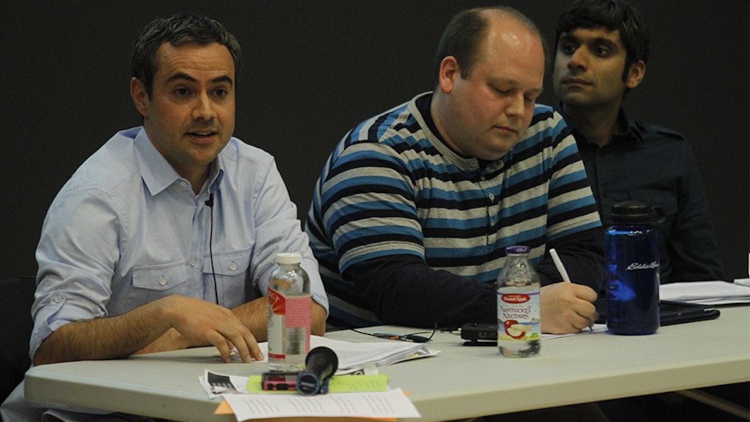 Yousuf Al-Bulushi, left, Nathan Swanson, middle, and Neel Ahuja participate in a forum.