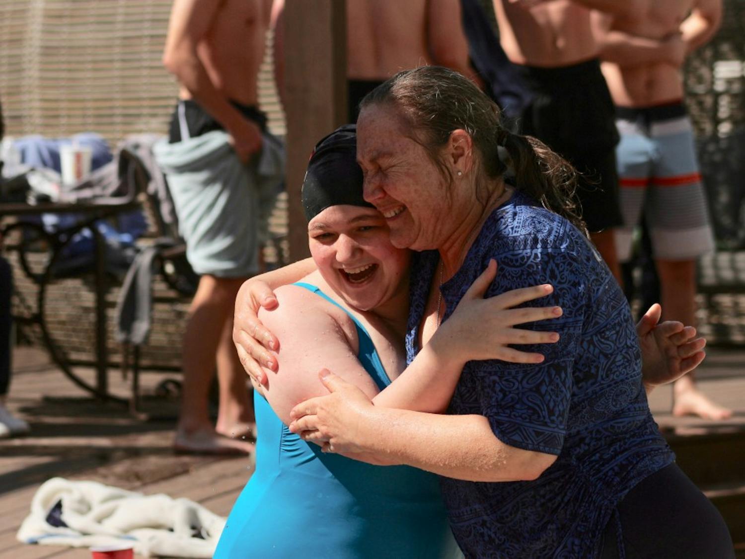 Chapel Hill mother and daughter, Ruth and Peri Thomson, hug following their jump into the frigid pool for UNC Special Olympics' Polar Plunge Fundraiser hosted at the Lark Chapel Hill pool on Saturday, March 2, 2019. Peri, 22, and has been swimming and cycling since the eighth grade.