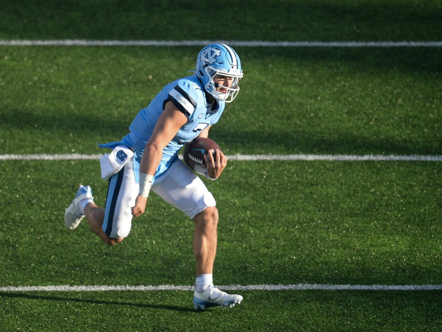 UNC's sophomore quarterback Sam Howell runs the ball downfield during a game in Kenan Memorial Stadium during a game against Wake Forest on Saturday, Nov. 14, 2020. UNC beat Wake Forest 59-53.