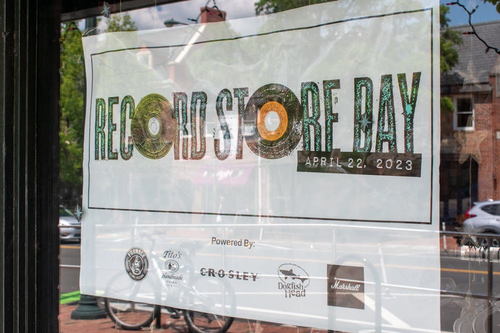 <p>A flyer for “Record Store Day” hangs outside of Schoolkids Records in Chapel Hill on Tuesday, April 25, 2023.</p>