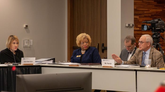 Vice-Chair Kellie Hunt Blue (left) and Seretary Pearl Burris-Floyd (middle left) observe as Committee Member R. Doyle Parrish (right) responds to aspects of a presented survey which collected data on various aspects of university faculty pay, retention, and participation across the UNC system and Historically Minority-serving institutions on Thursday, Jan. 24, 2019 at the UNC Center for School Leadership Development.