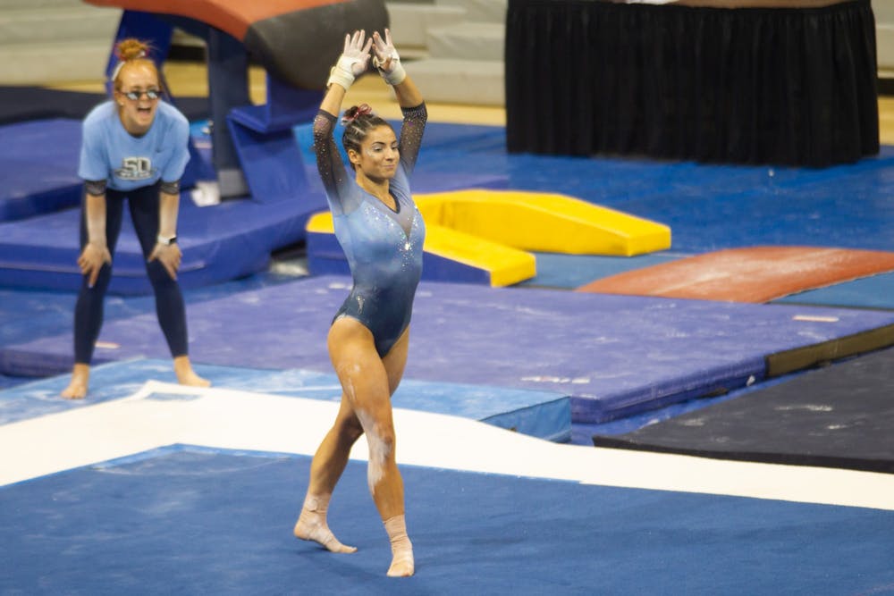 <p>Junior Bri Greenlow does her floor routine during a UNC Gymnastics meet in Carmichael Arena on Saturday, Feb. 12 2022 against Temple University as her teammate, sophomore Jamie Shearer, cheers her on.&nbsp;</p>
