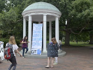 Members of SAW with their banner at the Old Well on Wednesday afternoon.  The banner was hung in hopes to gain the attention of Chancellor Folt and UNC students.