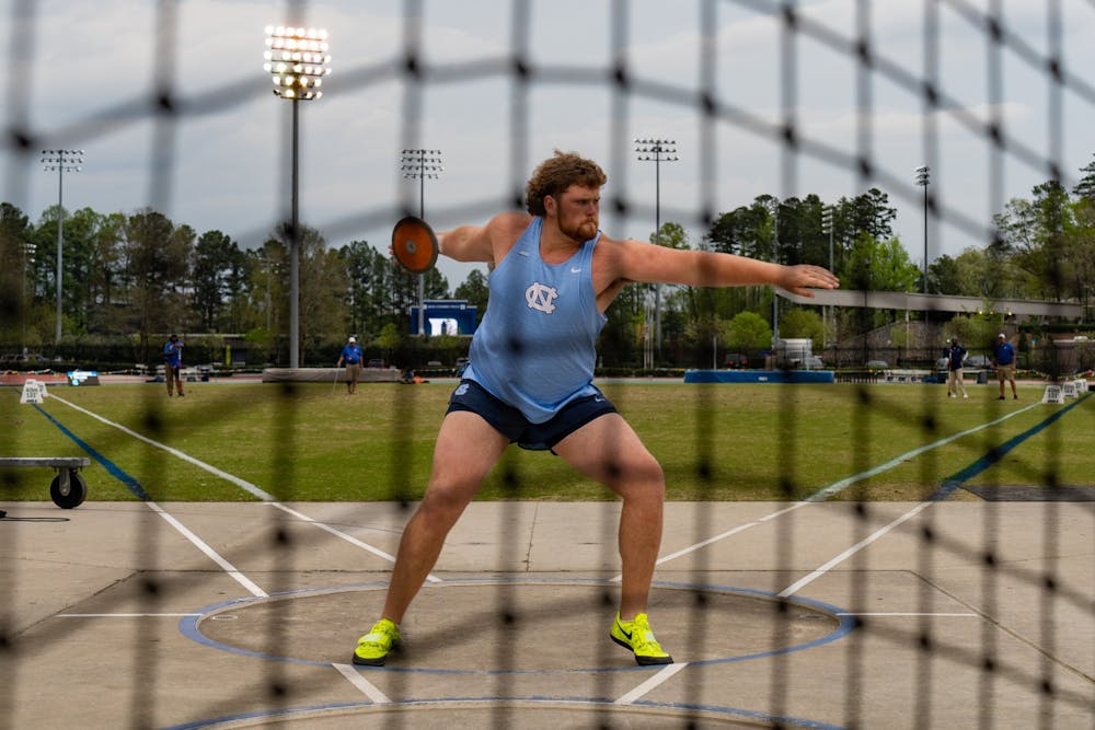 <p>UNC first-year Spencer Williams throws the discus during the track and field invitation at Duke University's &nbsp;Morris Williams stadium on Thursday, April 6, 2023.</p>