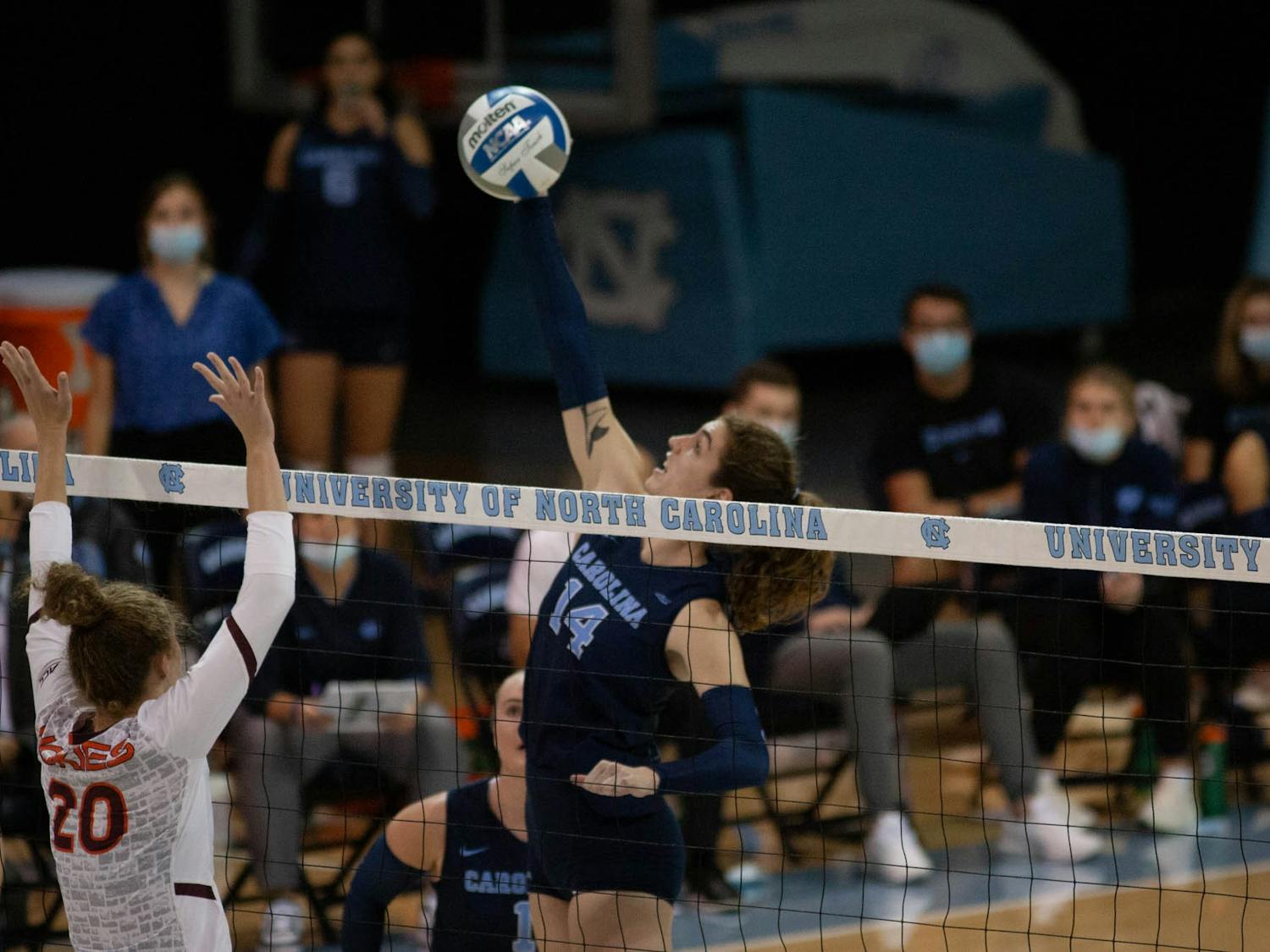 Sophomore middle and outside hitter Kaya Merkler (14) jumps to spike the ball in the UNC Women's volleyball game against Virginia Tech at the Woolen Gymnasium on Oct. 10. The Heels won 3-0.