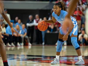 UNC redshirt first-year guard Kayla McPherson (14) sets up the play at the top of the key in the women's basketball game against the NC State Wolfpack at Reynolds Coliseum on Feb. 16, 2023. 