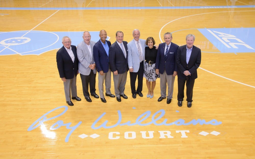 <p>University officials pose with Roy Williams at the dedication of Roy Williams Court on Aug. 24. Photo courtesy of the UNC athletic department. &nbsp;</p>