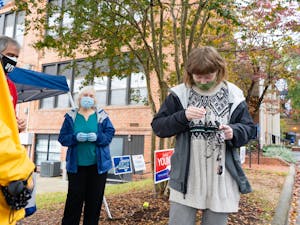 UNC sophomore Samantha Beecham puts on an "I Voted" sticker after voting at the Carrboro Town Hall on Sunday, Oct. 25, 2020.