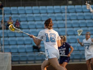 UNC redshirt first-year attacker Mackenzie Rich (18) plots her next move during the women’s lacrosse game against High Point at Dorrance Field on Thursday, March 23, 2023. UNC beat High Point 22-4.
