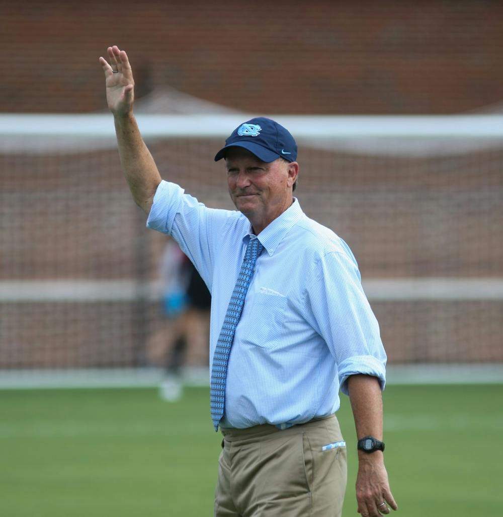 <p>UNC women's soccer team head coach Anson Dorrance waves to the crowd as he is being recognized during halftime of the soccer game against the Notre Dame Fighting Irish on Sunday, Sept. 29th, 2019 at the newly dedicated Dorrance Field.</p>