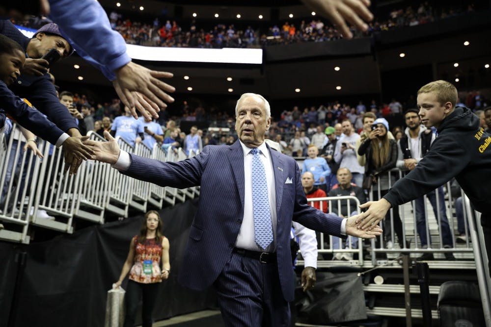 Head Coach Roy Williams high-fives fans as he enters the arena for the second round of the NCAA tournament against Washington at Nationwide Arena in Columbus, OH on Sunday, March 24, 2019. UNC defeated Washington 81-59.