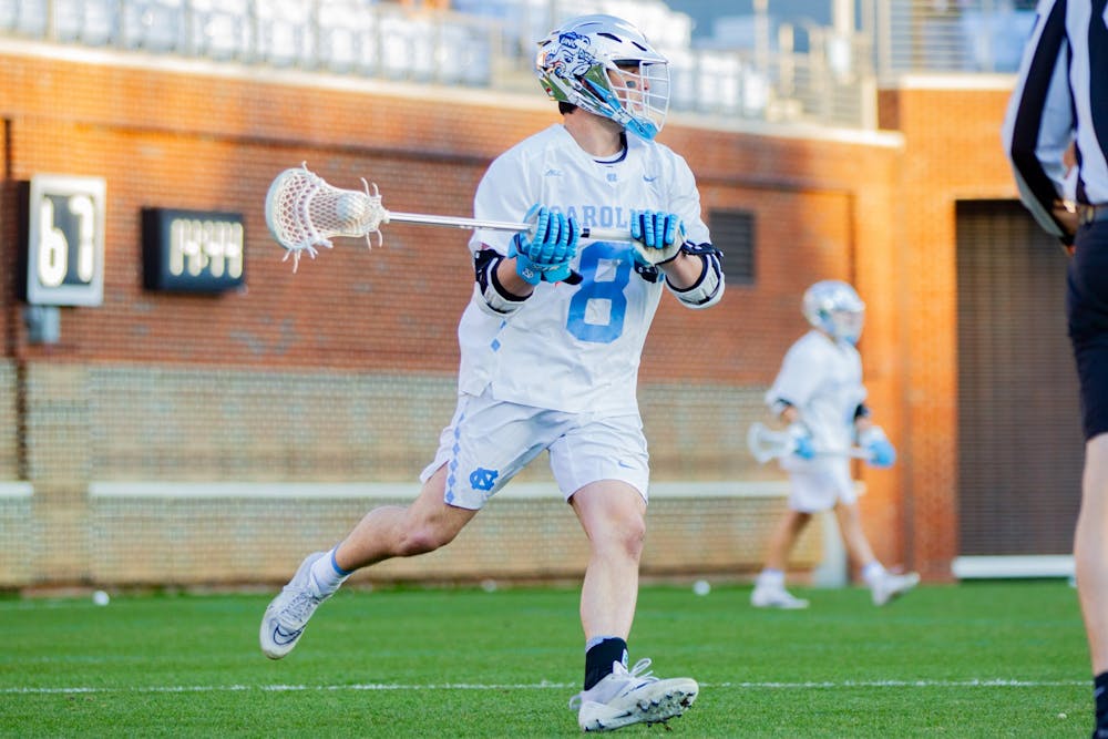 Senior attackman Nicky Solomon (8) runs with the ball at the men's lacrosse game against Richmond on Feb. 11, 2022 at Dorrance Field in Chapel Hill. UNC won 13-9.