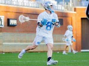 Senior attackman Nicky Solomon (8) runs with the ball at the men's lacrosse game against Richmond on Feb. 11, 2022 at Dorrance Field in Chapel Hill. UNC won 13-9.