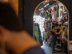 Shoppers browse the racks at Rumors, a thrift boutique on N. Graham St., on June 9, 2022.
