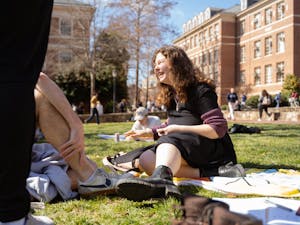 Sophomore Julia Finke laughs with her friends on the quad during a warm sunny day on Monday, Feb. 21, 2022.