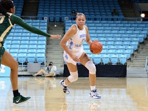UNC graduate guard Stephanie Watts (5) avoids UNC Charlotte players during a game in Carmichael Arena on Sunday, Dec. 6, 2020. UNC beat UNCC 81-75. Photo courtesy of UNC Athletic Communications.&nbsp;