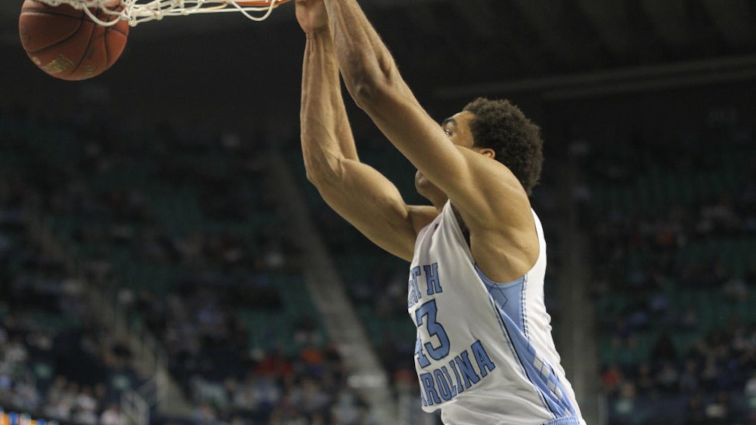 	James Michael McAdoo slams one down. McAdoo was assisted by a bounce pass from Marcus Paige.