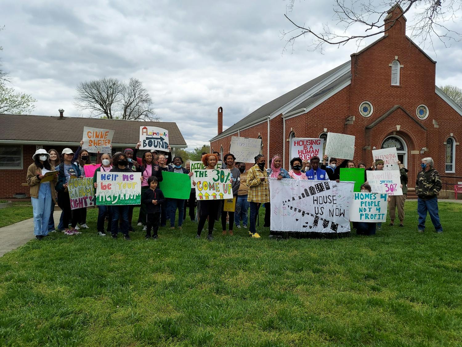 Demonstrators began at the Peace and Justice Plaza and marched to the Marian Cheek Jackson Center on Saturday to bring attention to the town’s lack of affordable housing.