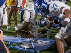 The UNC football team celebrates their win after the game against Duke on Saturday, Oct. 15, 2022, at the Wallace Wade Stadium. UNC beat Duke 38-35.
