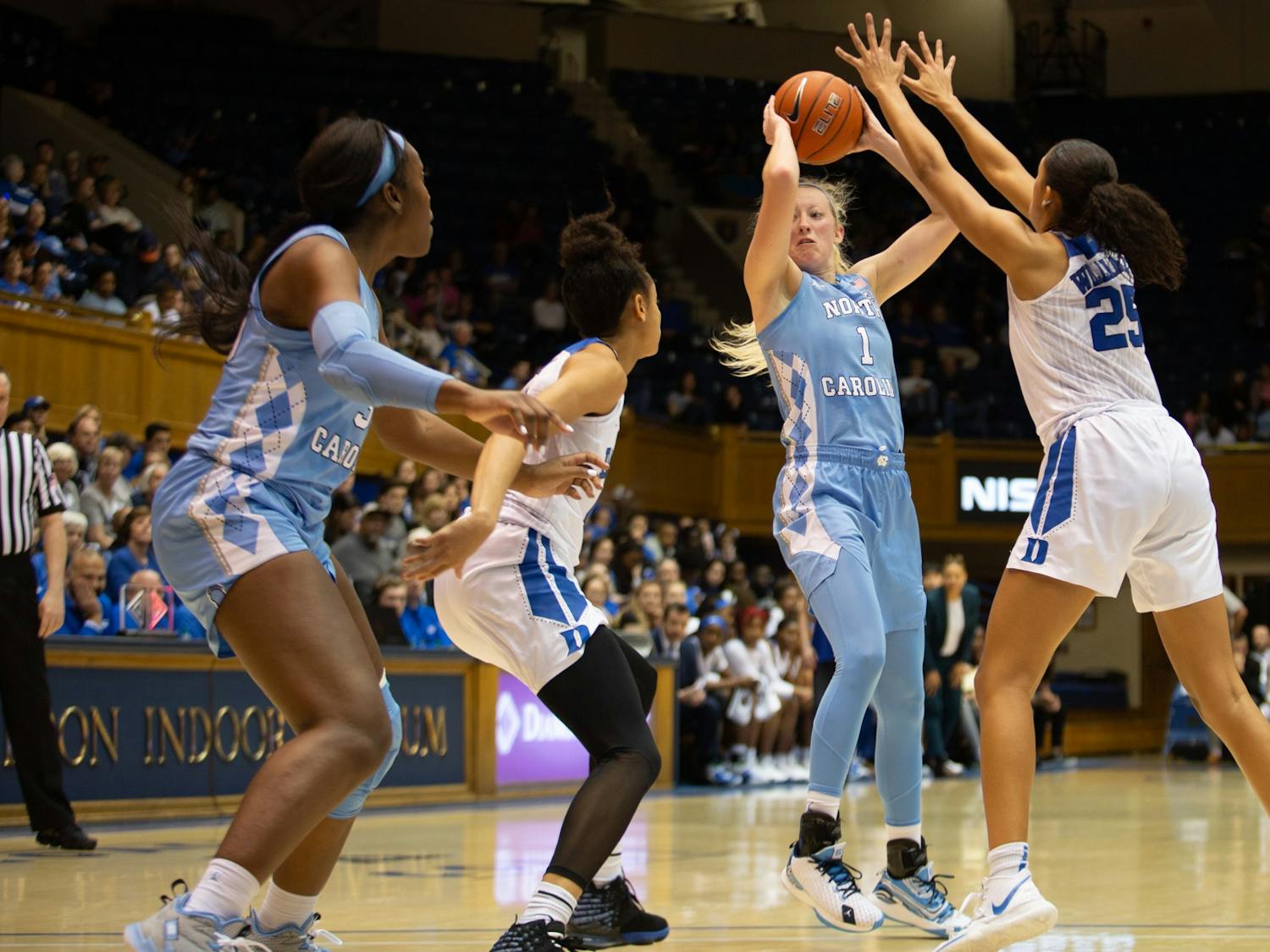 UNC senior guard Taylor Koenen (1) shoots while being defended by Duke  junior forward/center Jade Williams (25).  The Tar Heels lost to Duke 61-71 in Cameron Indoor Stadium on Thursday, Feb. 6, 2020.