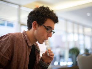 UNC sophomore Jaden Passero collects a sample in a test tube for COVID-19 testing at the FPG Student Union on Wednesday, Sept. 30, 2020.