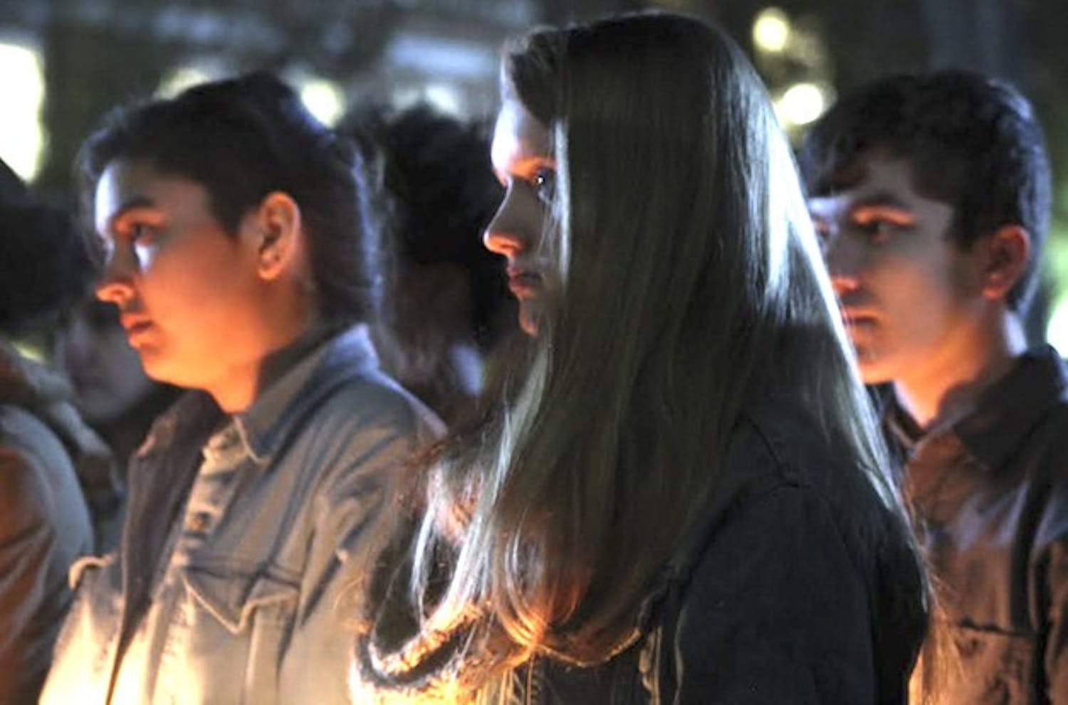 Students gather on the steps of Wilson Library Friday to attend a vigil honoring the lost and threatened lives in the transgender community.