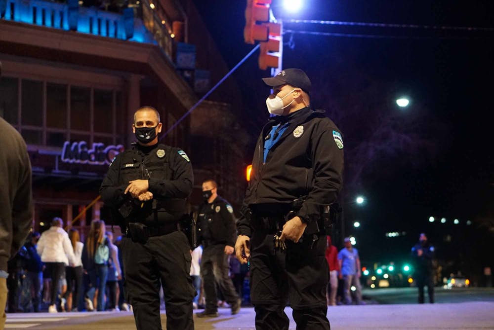 Chapel Hill police are stationed on Franklin Street during the UNC vs Duke basketball game on March 5, 2021. Police were present in an attempt to prevent students from rushing Franklin Street.