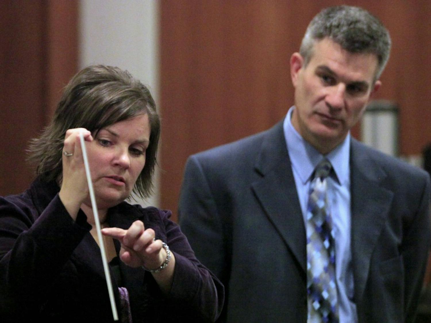 Celisa Lehew with Chapel Hill Police shows the jurors a photograph of the house Eve Carson lived. Next to her is Orange County DA James Woodall, Jr. The trial of Laurence Alvin Lovette Jr., the second man who is charged in the death of UNC-Chapel Hill Student Body President Eve Carson in March 2008, continued at Orange County Courthouse Monday, Dec. 12, 2011. 
